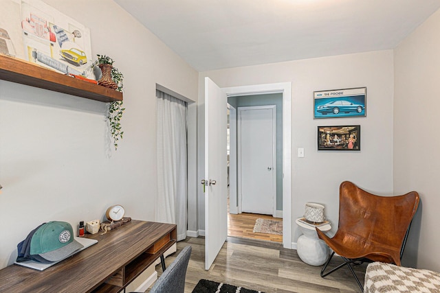 interior space featuring light wood-type flooring and baseboards