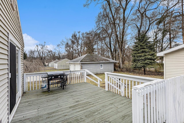 deck featuring a grill, an outdoor structure, and fence