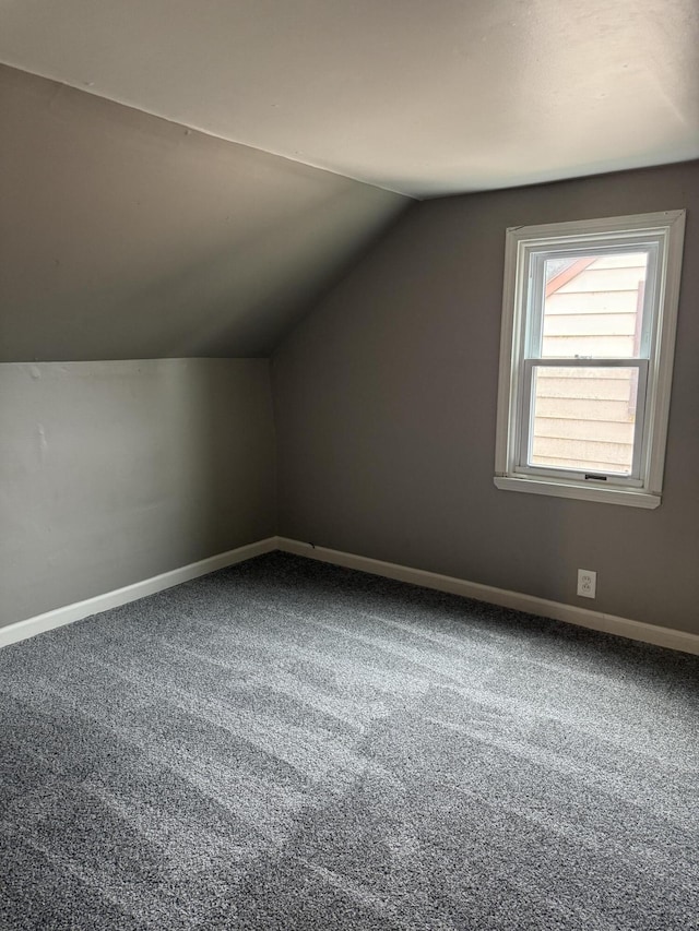 bonus room with carpet floors, lofted ceiling, and baseboards