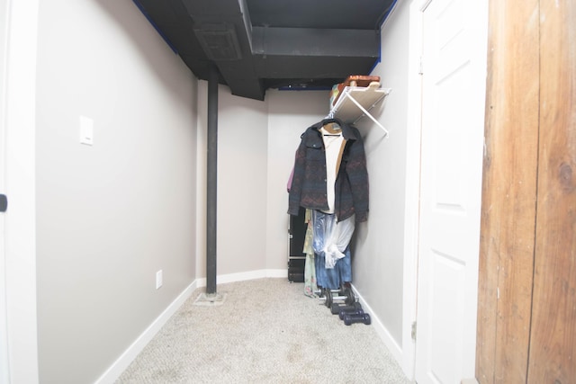 walk in closet with carpet flooring