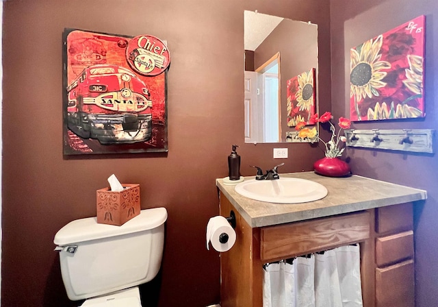 bathroom with toilet and vanity