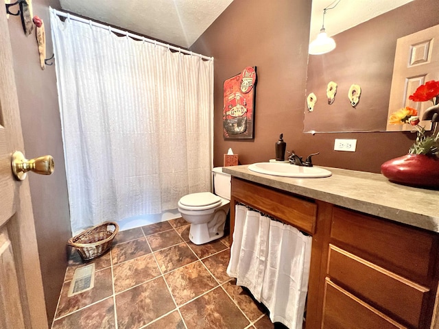 bathroom with visible vents, toilet, vanity, a shower with curtain, and tile patterned floors