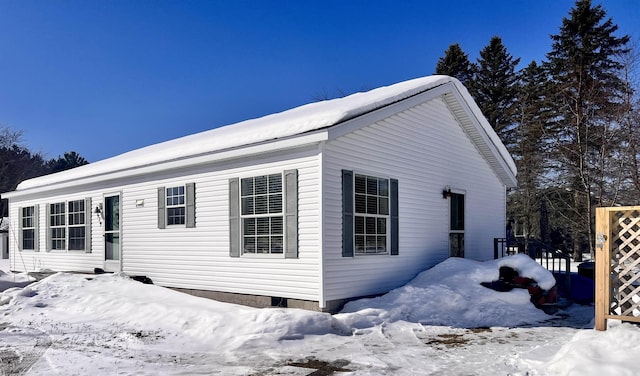 view of snowy exterior with crawl space