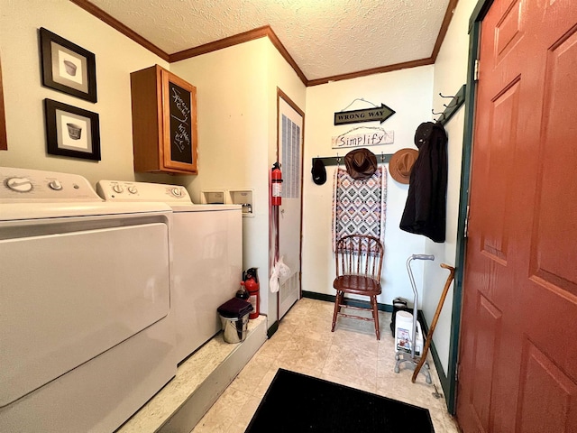 laundry room with ornamental molding, washing machine and dryer, a textured ceiling, laundry area, and baseboards