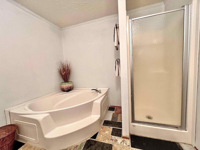 bathroom featuring crown molding, a shower stall, a textured ceiling, and a bath