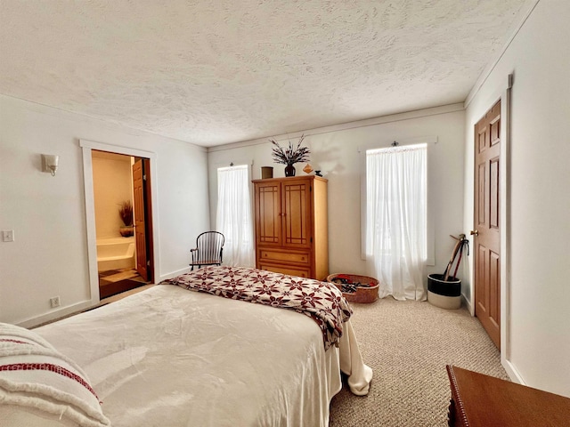 bedroom with a textured ceiling, carpet floors, and baseboards