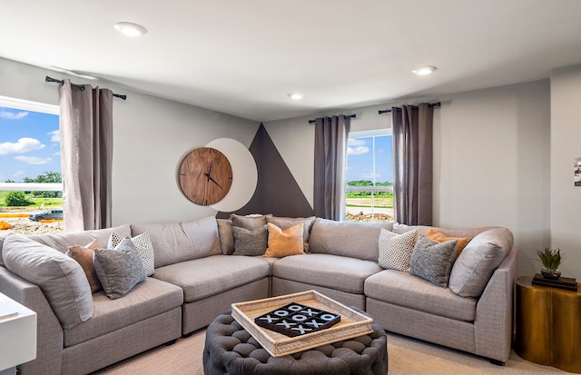 living area with light carpet and recessed lighting