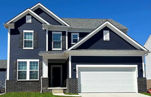 view of front of home featuring driveway, an attached garage, and brick siding