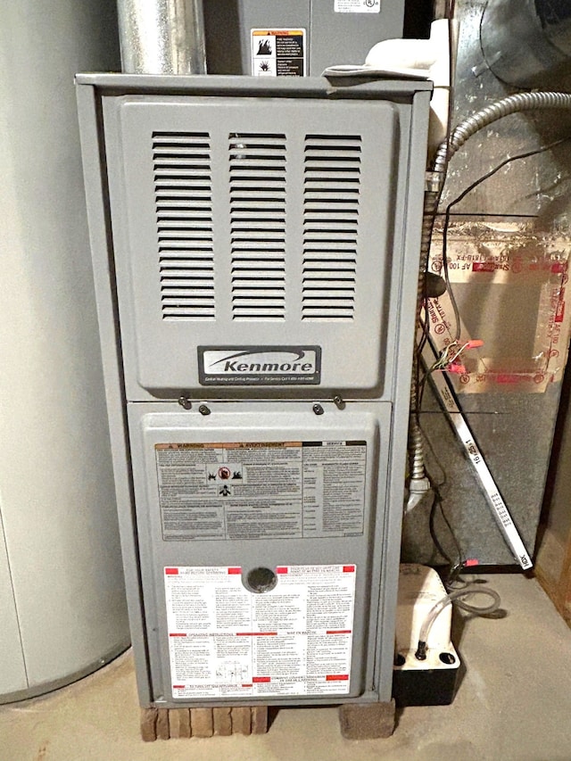 utility room featuring heating unit