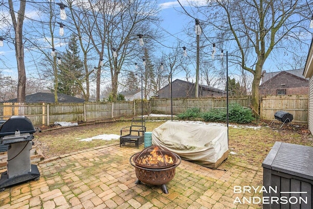 view of patio / terrace with a fenced backyard, a fire pit, and grilling area