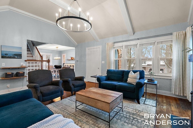 living room with high vaulted ceiling, wood finished floors, baseboards, stairs, and an inviting chandelier