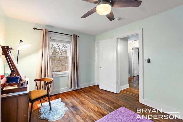 living area with ceiling fan, baseboards, and wood finished floors