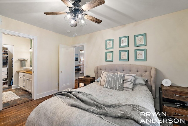 bedroom with dark wood-style floors, baseboards, a ceiling fan, and ensuite bathroom