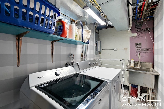 clothes washing area featuring laundry area, electric panel, a sink, and independent washer and dryer