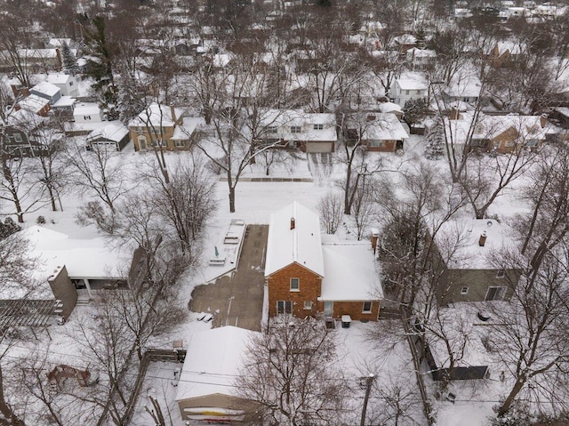 snowy aerial view with a residential view