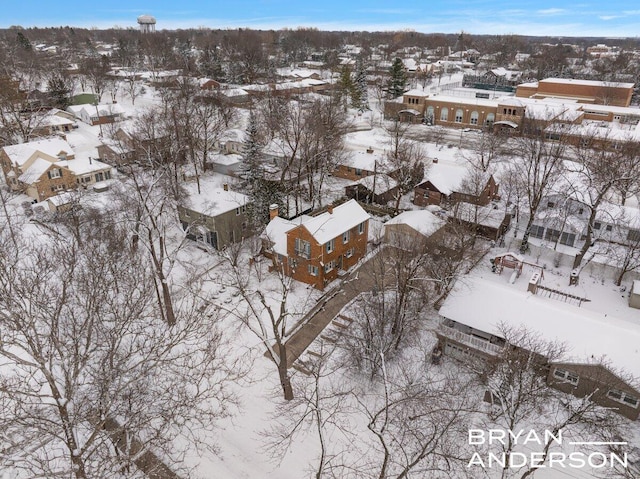 snowy aerial view featuring a residential view