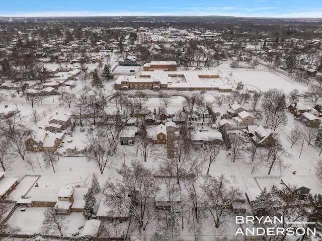 snowy aerial view featuring a residential view