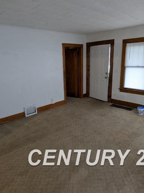 interior space with carpet, visible vents, and baseboards