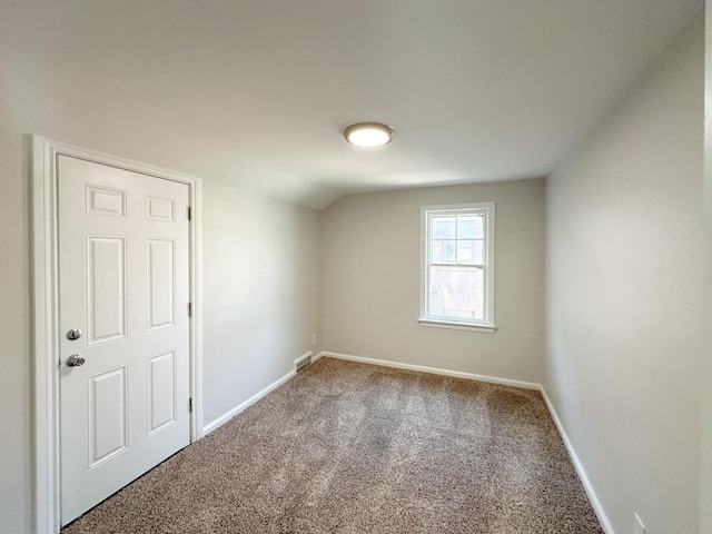 additional living space with lofted ceiling, carpet flooring, visible vents, and baseboards