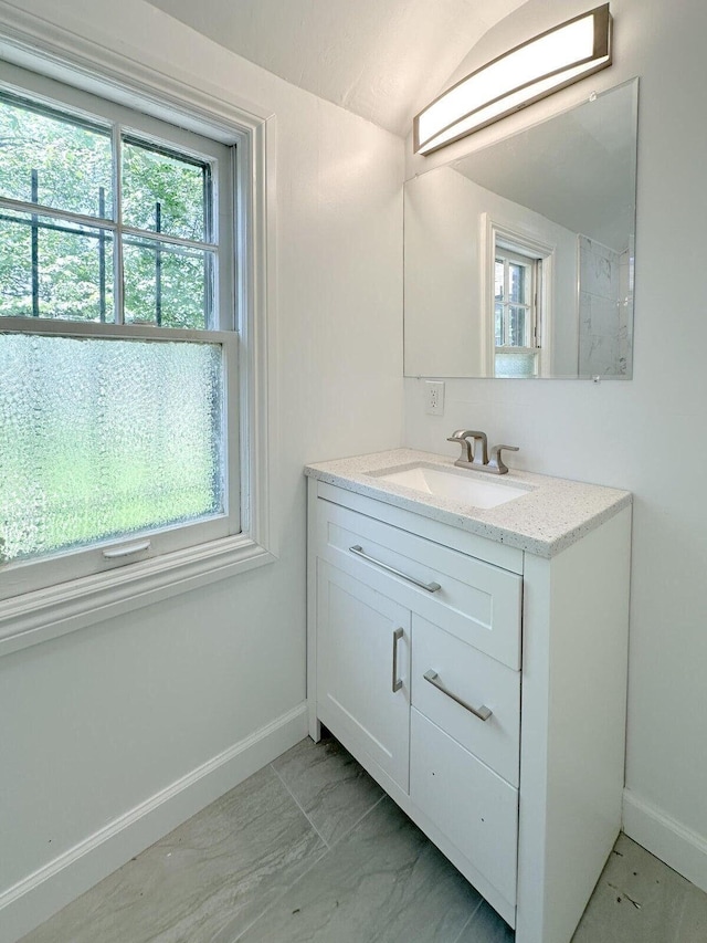 bathroom featuring vanity and baseboards