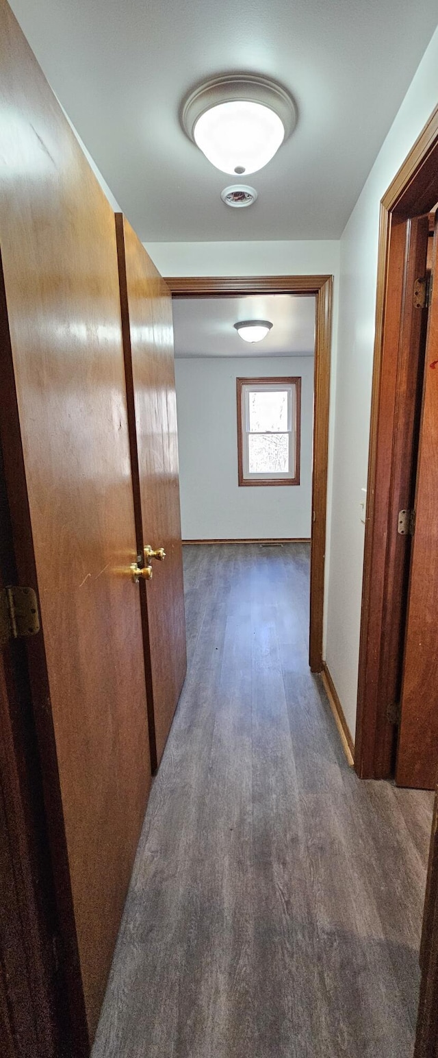 hall featuring dark wood finished floors and baseboards