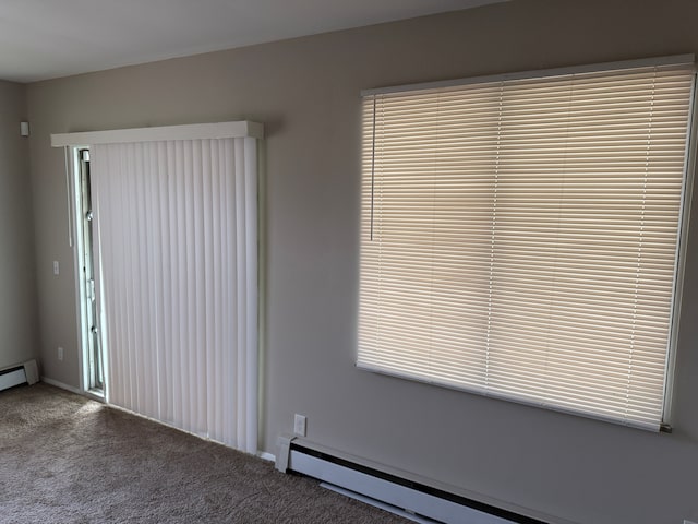 unfurnished room featuring a baseboard radiator, baseboard heating, and carpet