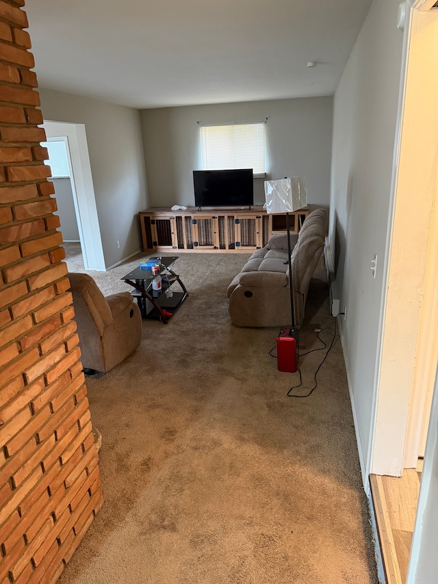 carpeted living room with baseboards