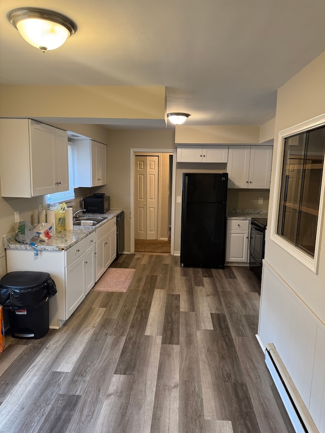 kitchen with black appliances, light stone counters, dark wood-style floors, white cabinetry, and baseboard heating