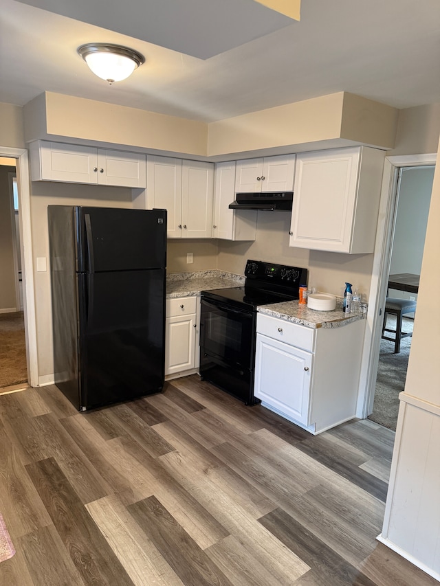 kitchen featuring under cabinet range hood, white cabinets, black appliances, and dark wood-style flooring