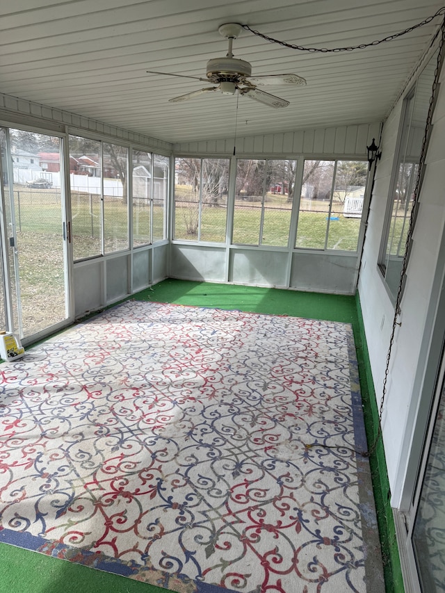 unfurnished sunroom with a ceiling fan