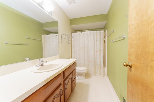 full bathroom featuring toilet, vanity, visible vents, and tile patterned floors