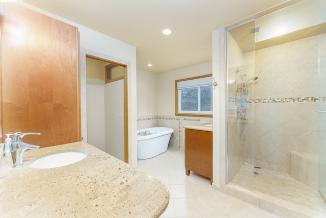 bathroom featuring recessed lighting, vanity, a freestanding bath, tile patterned floors, and a stall shower