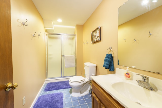 full bath featuring tile patterned flooring, toilet, vanity, baseboards, and a stall shower