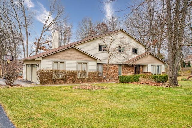 view of front of house with a garage, a chimney, aphalt driveway, and a front yard