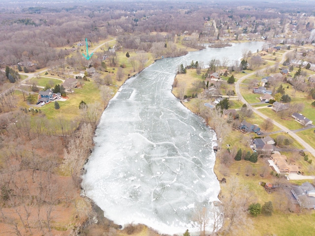 aerial view with a water view and a wooded view