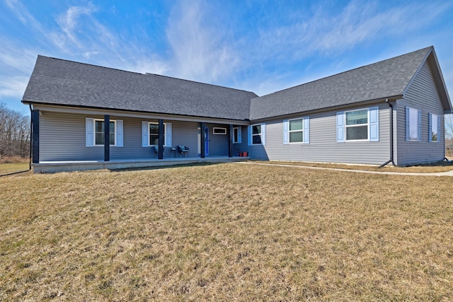 single story home featuring roof with shingles and a front yard