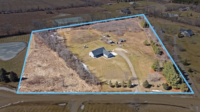 birds eye view of property with a rural view