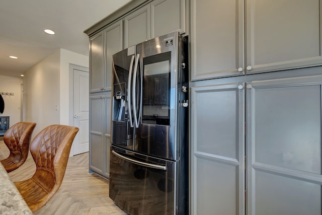 kitchen featuring recessed lighting, gray cabinets, and stainless steel fridge with ice dispenser