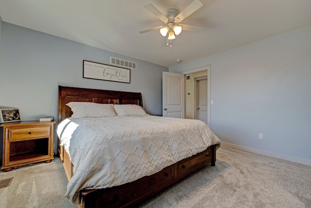 bedroom featuring a ceiling fan, light colored carpet, visible vents, and baseboards