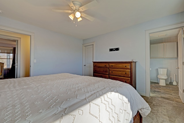 carpeted bedroom featuring baseboards, ceiling fan, and ensuite bath