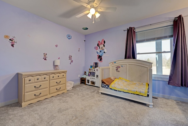 carpeted bedroom featuring ceiling fan and baseboards