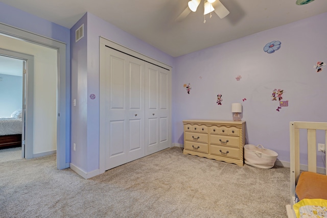 bedroom with a ceiling fan, visible vents, baseboards, a closet, and carpet