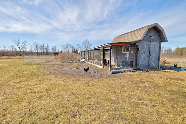 view of yard featuring an outbuilding and exterior structure