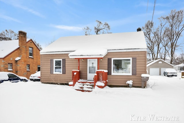 bungalow-style home with an outbuilding and a detached garage