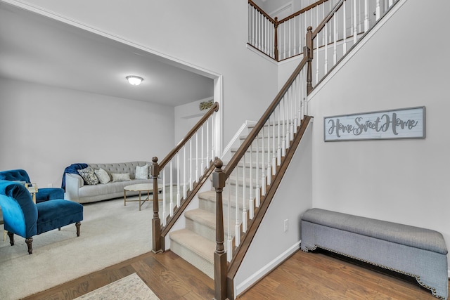 stairway with baseboards and wood finished floors