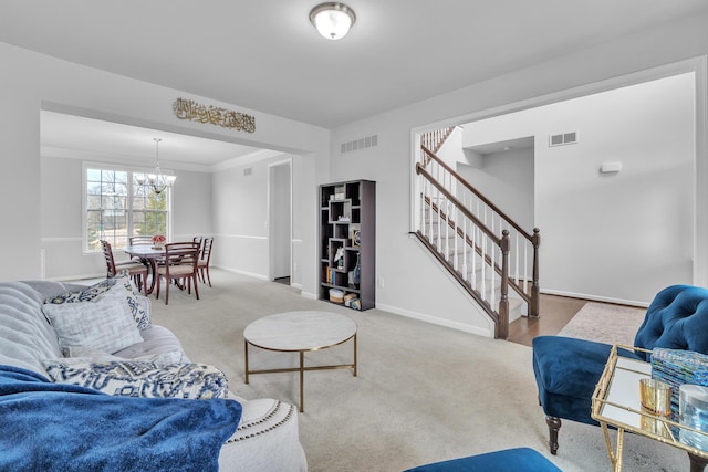 carpeted living room featuring a chandelier, visible vents, baseboards, and stairs