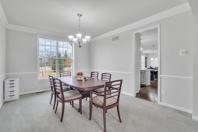 carpeted dining area with a wealth of natural light, crown molding, and a notable chandelier