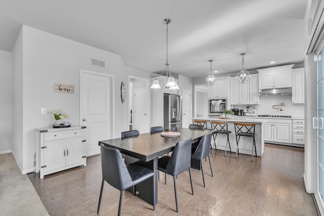 dining space with baseboards, visible vents, dark wood finished floors, and recessed lighting