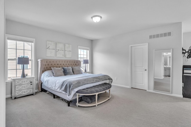 carpeted bedroom featuring visible vents and baseboards