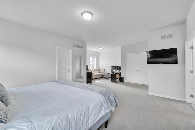 bedroom featuring carpet floors, visible vents, and baseboards